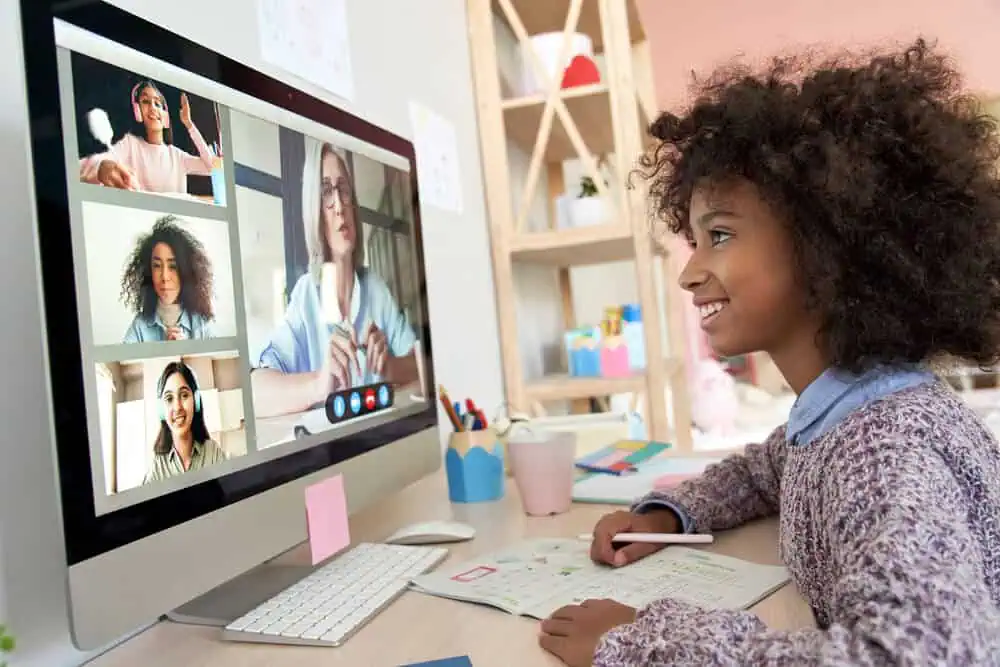 Student engaging in online learning with a teacher via video conference.