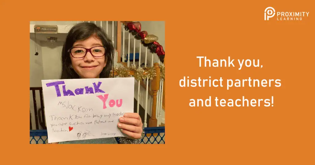 Student holding thank you sign for district partners and teachers at Proximity Learning.