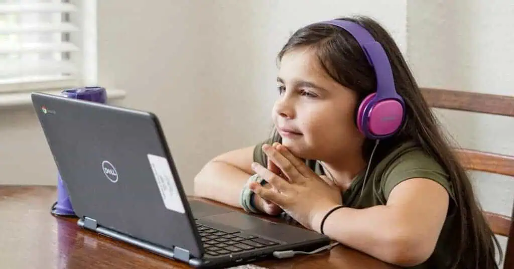 Student listens intently to certified virtual teacher on the computer.