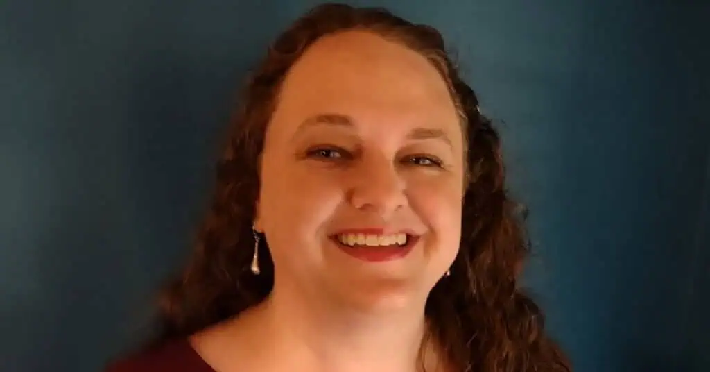 Proximity Learning educator smiling during online teaching session.