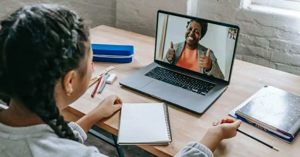 Student video conferences virtual teacher for personalized instruction.