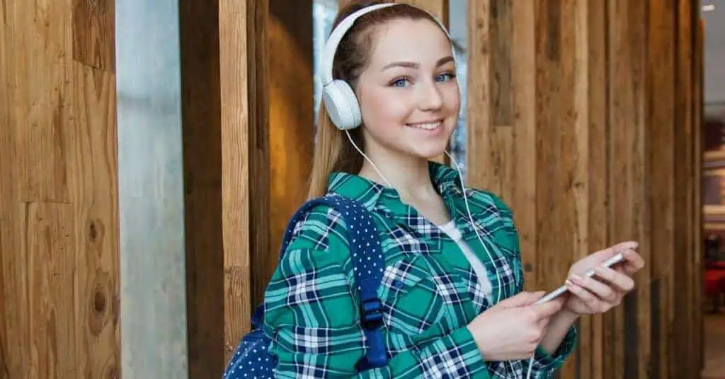 student listens through headphones