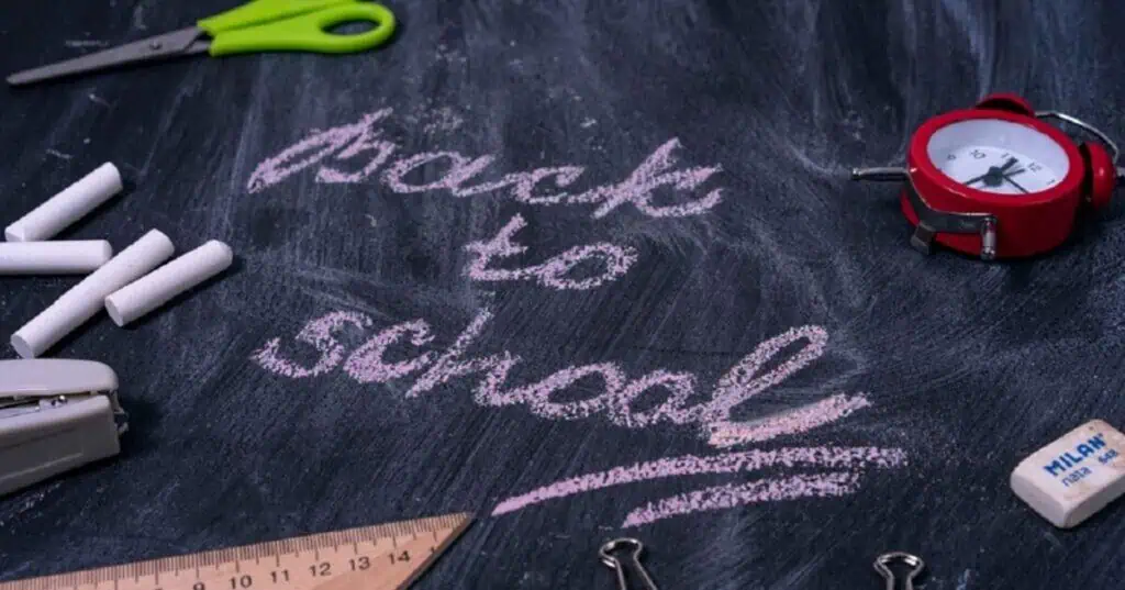 Proximity Learning chalkboard with school supplies for remote education.
