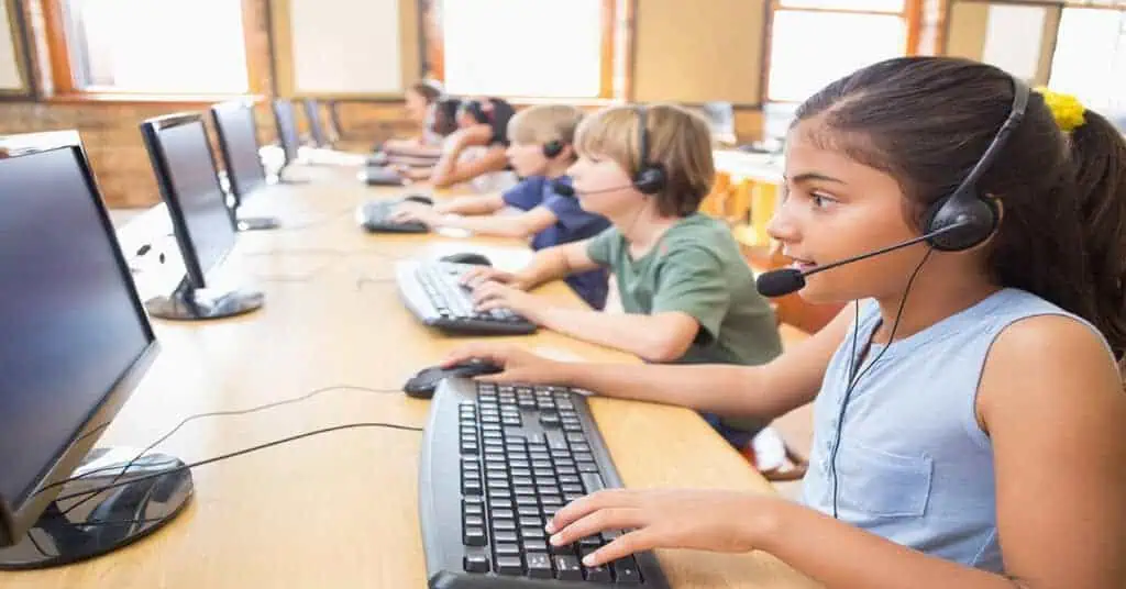 Students in a virtual classroom with headsets learning remotely.
