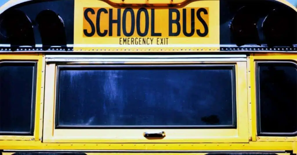 School bus emergency exit sign on yellow bus, safety feature for students.