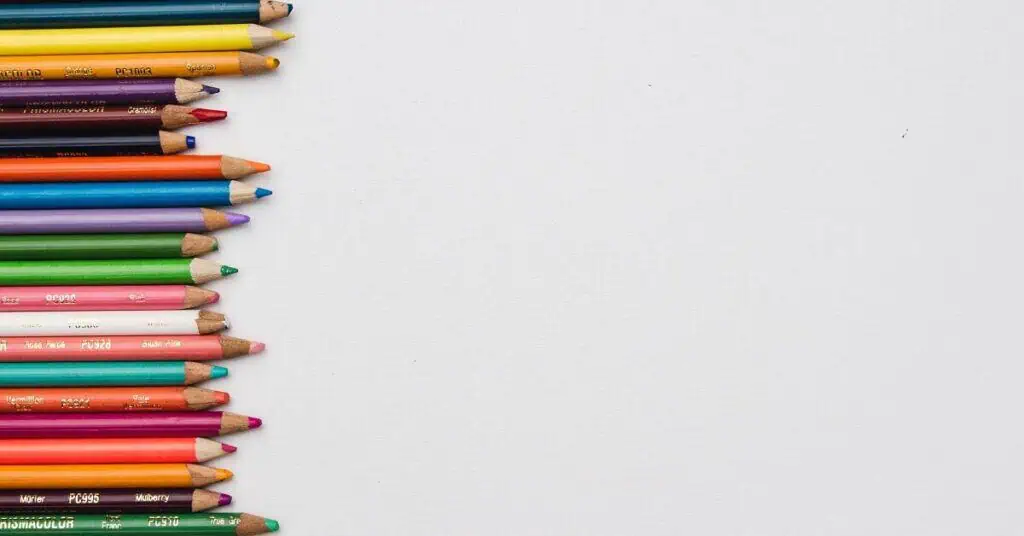 A line of rainbow colored pencils.