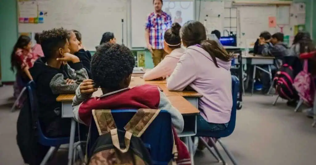Students sitting in a modern hybrid classroom where they are learning with nontraditional teaching methods.