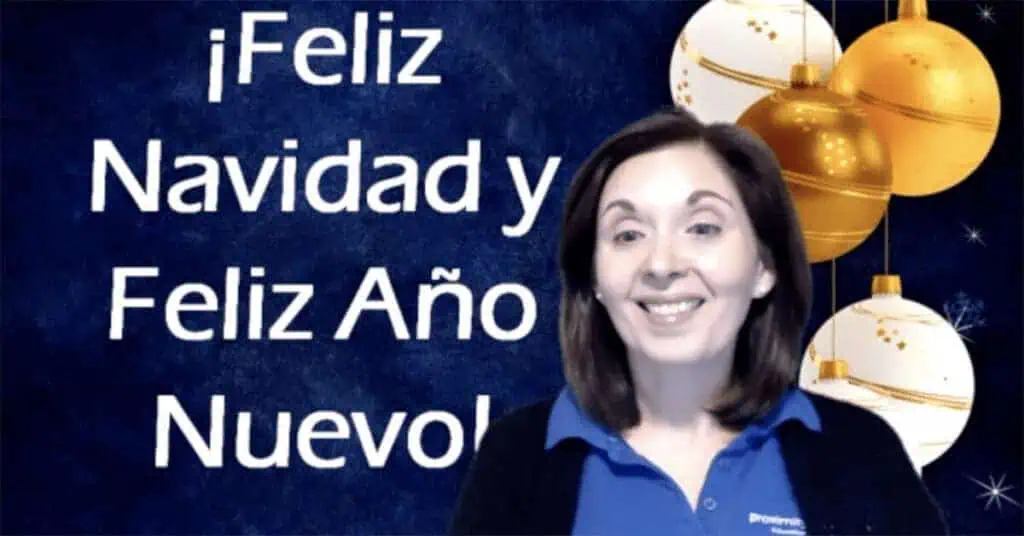 Woman smiling with Christmas ornaments and holiday message in the background.