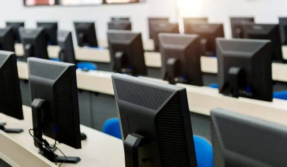 Modern computer lab with multiple desktops for remote learning and virtual classrooms.