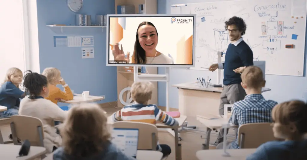 Virtual classroom with teacher on screen and students in a modern learning environment.