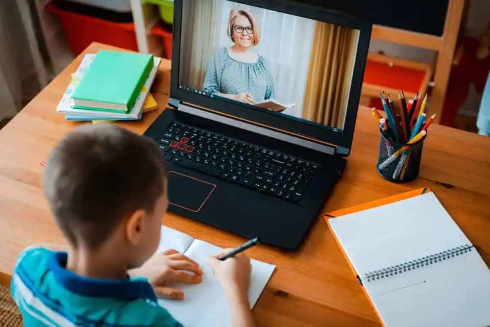 Child studying online school class at home.