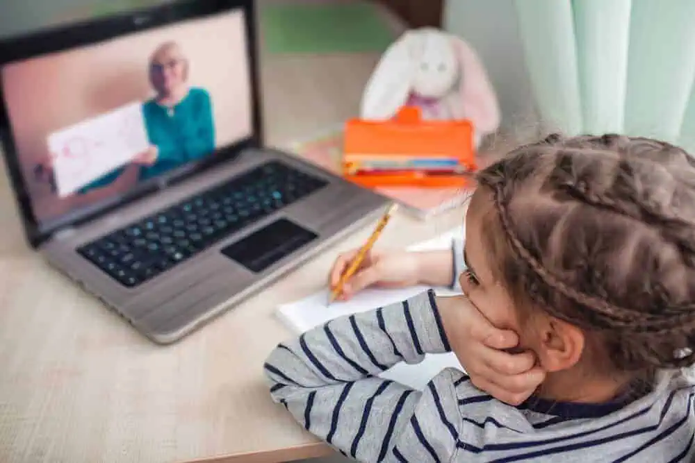 Child listening to pre-recorded class.