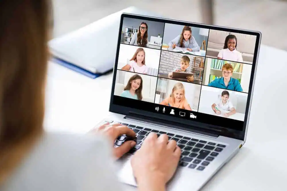 Teacher with students in virtual classroom.