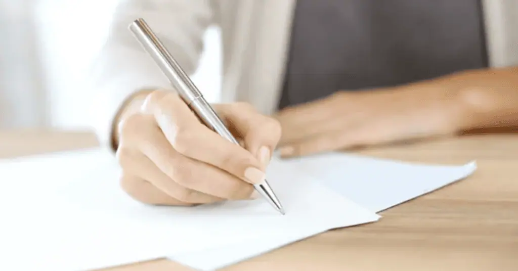 image of a hand singing a contract letter of intent