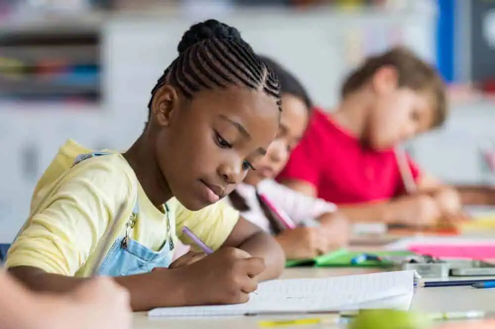 White and African-American students studying together in class