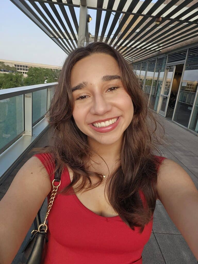 Proximity Learning woman smiling on balcony.