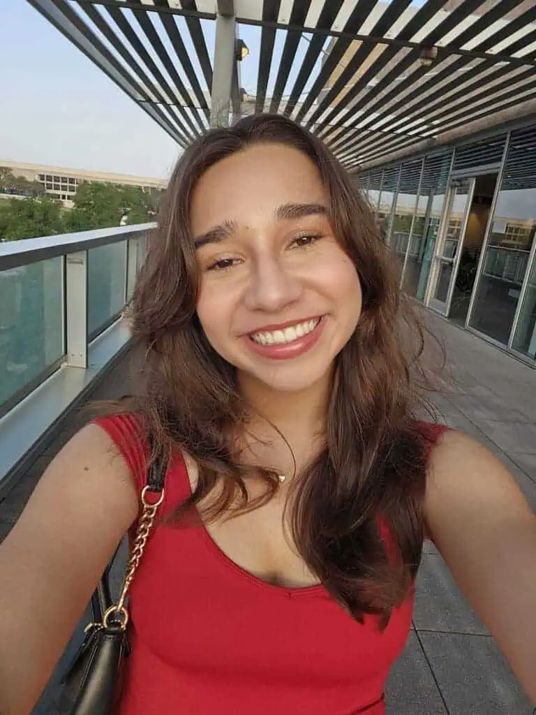 Proximity Learning woman smiling on balcony.