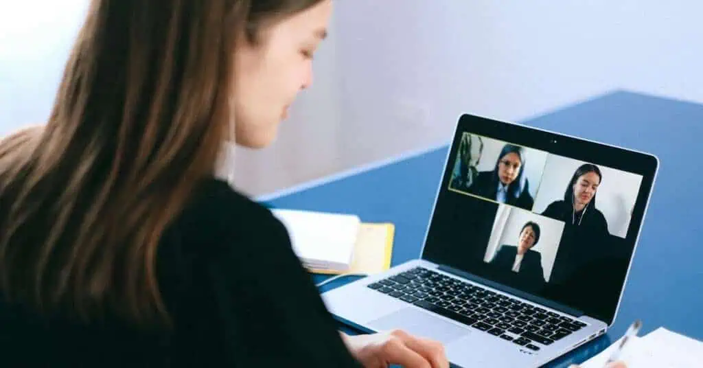 A girl is connected to her virtual school through her laptop
