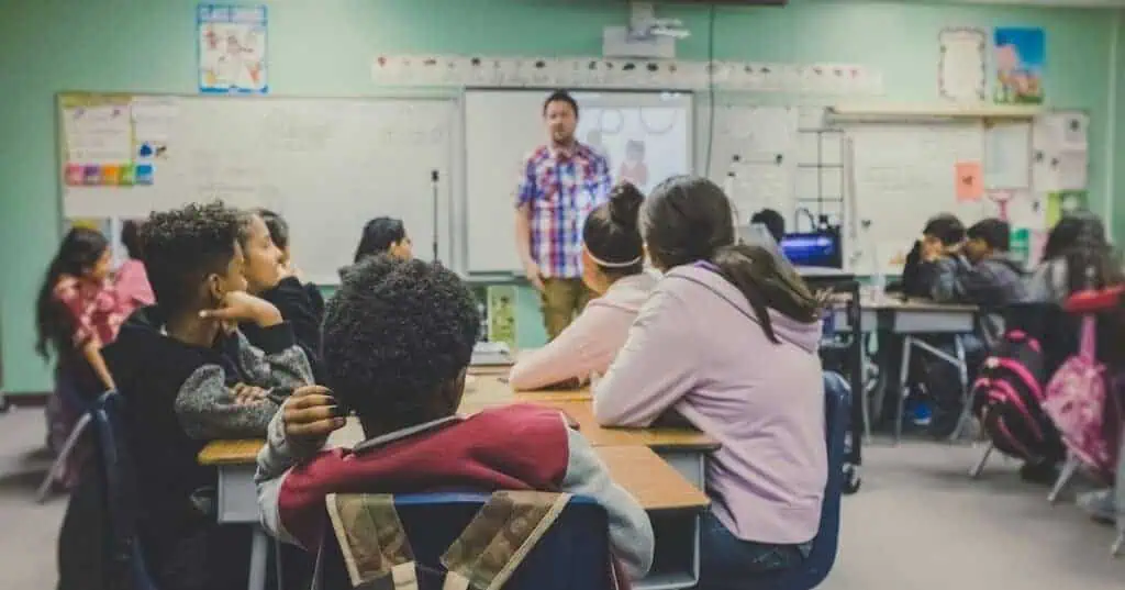 Students are seated in groups in their classroom