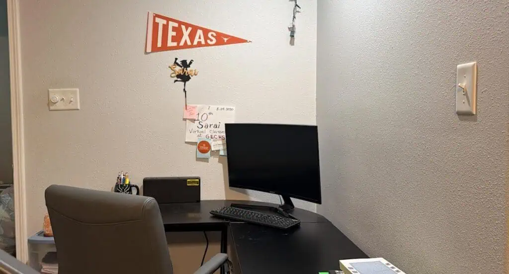 A first day of virtual classes and a Texas sign hangs above a computer desk.
