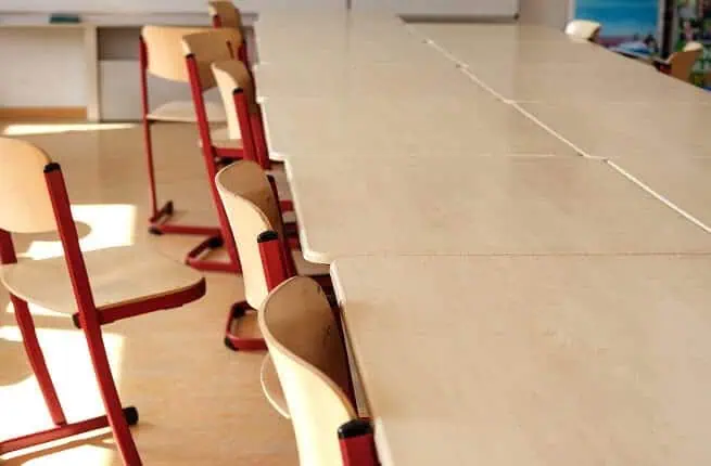 Empty classroom with chairs and tables for remote learning sessions.