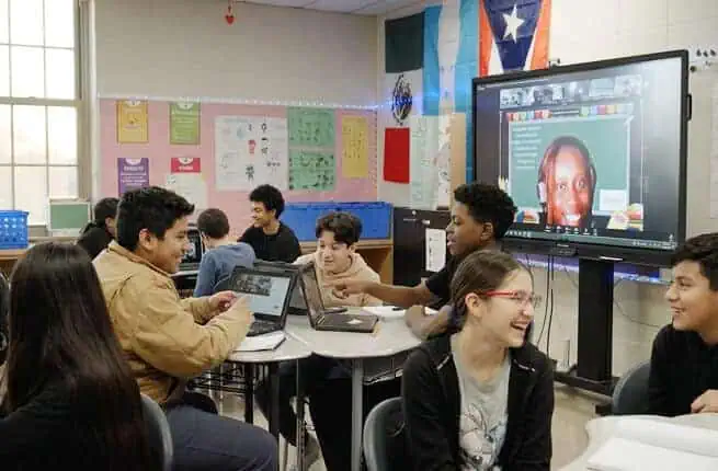 Students engaging in interactive virtual learning with Proximity Learning technology.