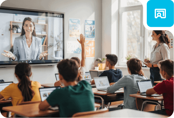 Students engaging in a virtual classroom with a teacher on a large screen.