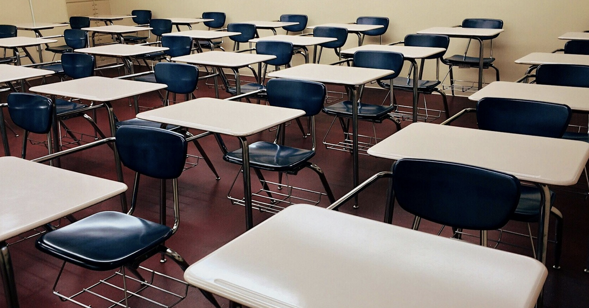 classroom full of empty desks from teacher shortage