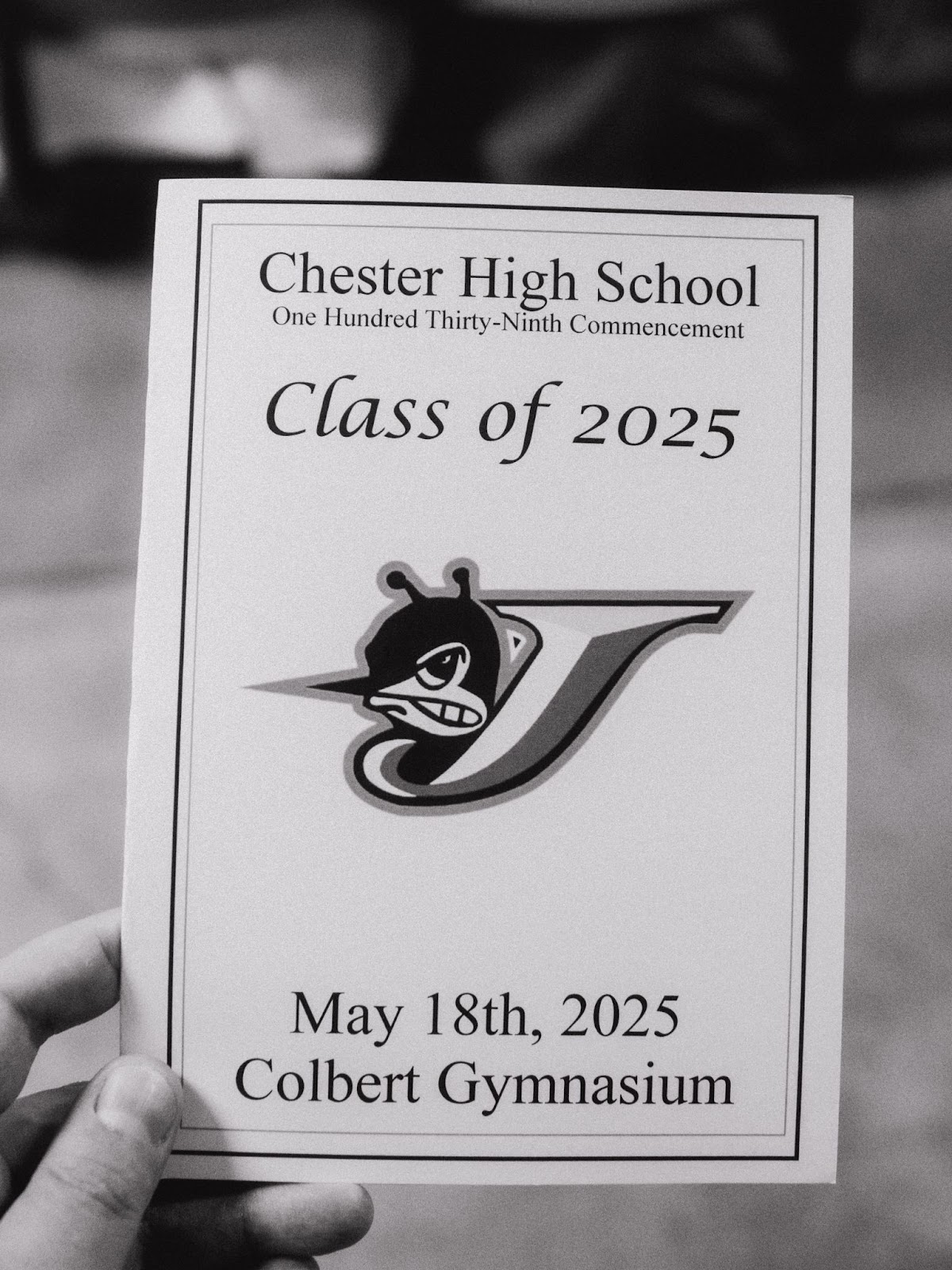 a hand hold a commencement program