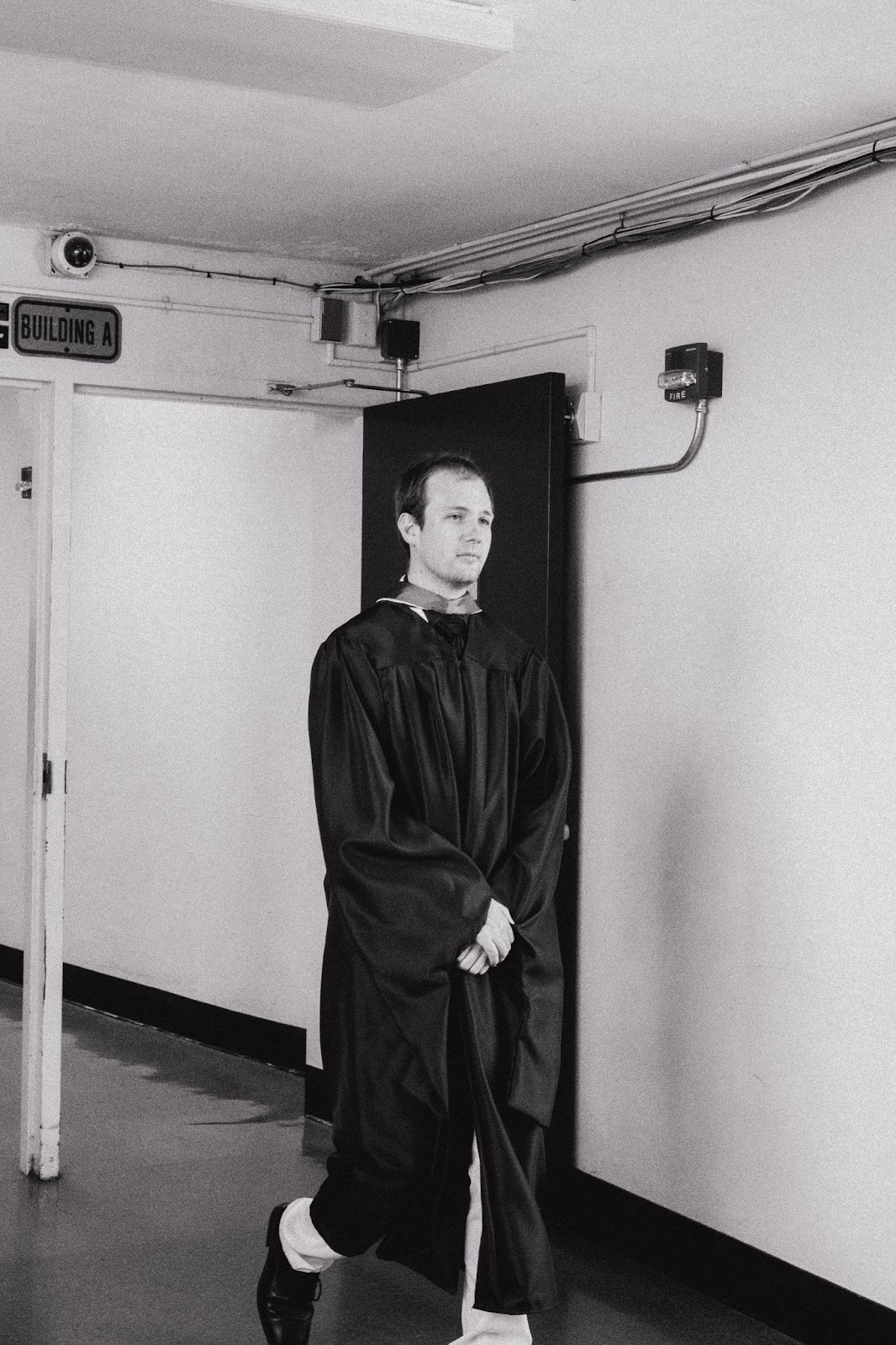 teacher walks in graducation regalia