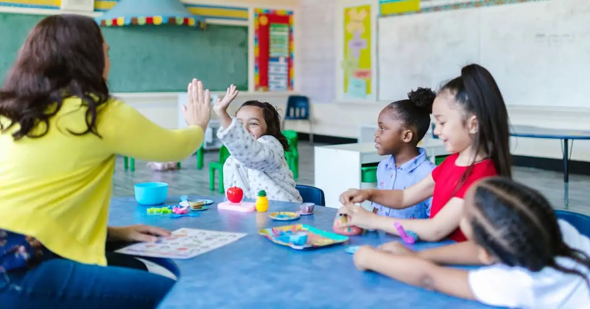 Teacher engaging with diverse students in a classroom setting.