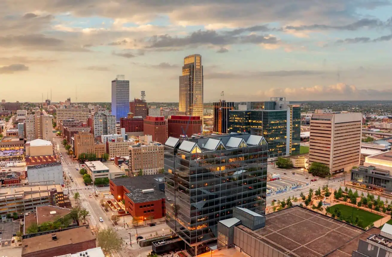Omaha city skyline with tall buildings at sunset in Nebraska.